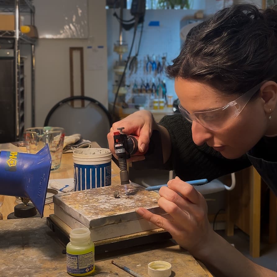artist Erica forming a ring with tweezers and a butane torch